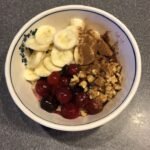 Bowl of oats, walnuts, bananas, and tart cherries – natural foods that boost melatonin and improve sleep