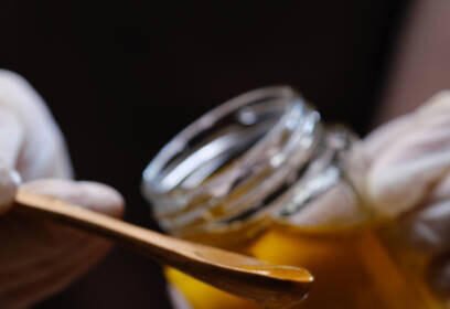 Bowls with natural ingredients like honey, turmeric, avocado, and cucumber for homemade facial masks