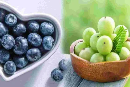 Fresh blueberries and sliced amla fruit placed side by side