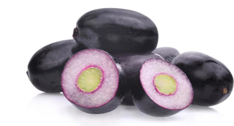 Bowl of jamun seed powder with a spoon