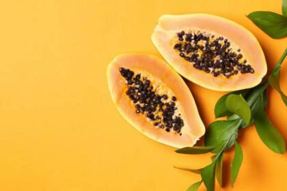 Papaya lemon juice served fresh in a glass with papaya slices