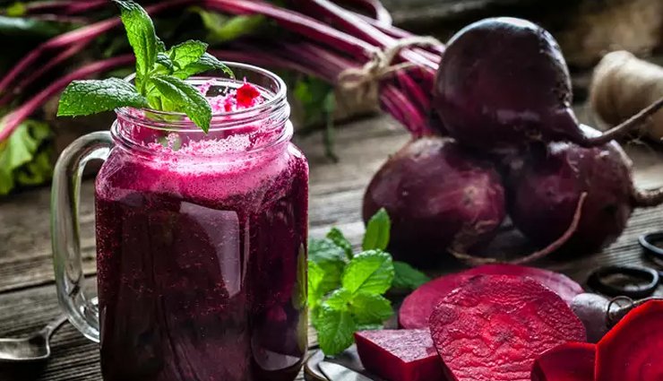 Beetroot juice in glass with raw beets for better hair health