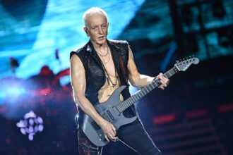 Def Leppard guitarist Phil Collen performing on stage and discussing his vegetarian lifestyle influenced by Indian culture.