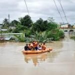 Severe Weather Flood Alert in Tripura showing heavy rain, flooded streets, and emergency response teams