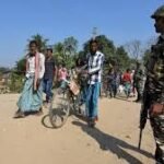 Officials reviewing documents and conducting checks during deportation drive in Assam