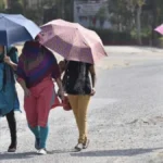 People walking under intense summer heat in Purulia district during West Bengal heatwave conditions