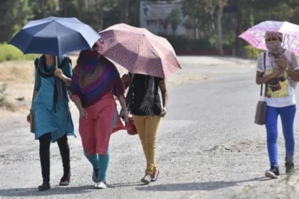 People walking under intense summer heat in Purulia district during West Bengal heatwave conditions