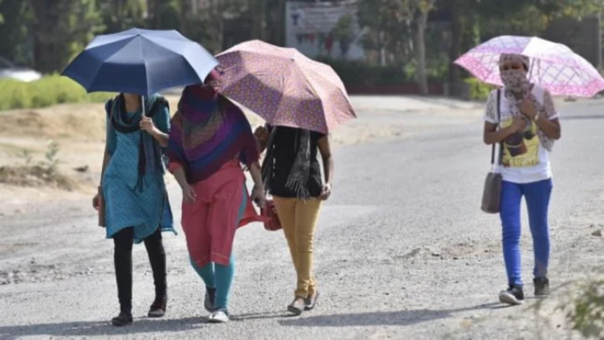 People walking under intense summer heat in Purulia district during West Bengal heatwave conditions