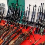 Security personnel displaying recovered INSAS rifles and grenades after operation at Langol hill in Manipur