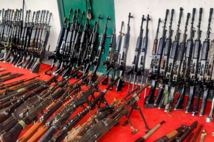 Security personnel displaying recovered INSAS rifles and grenades after operation at Langol hill in Manipur