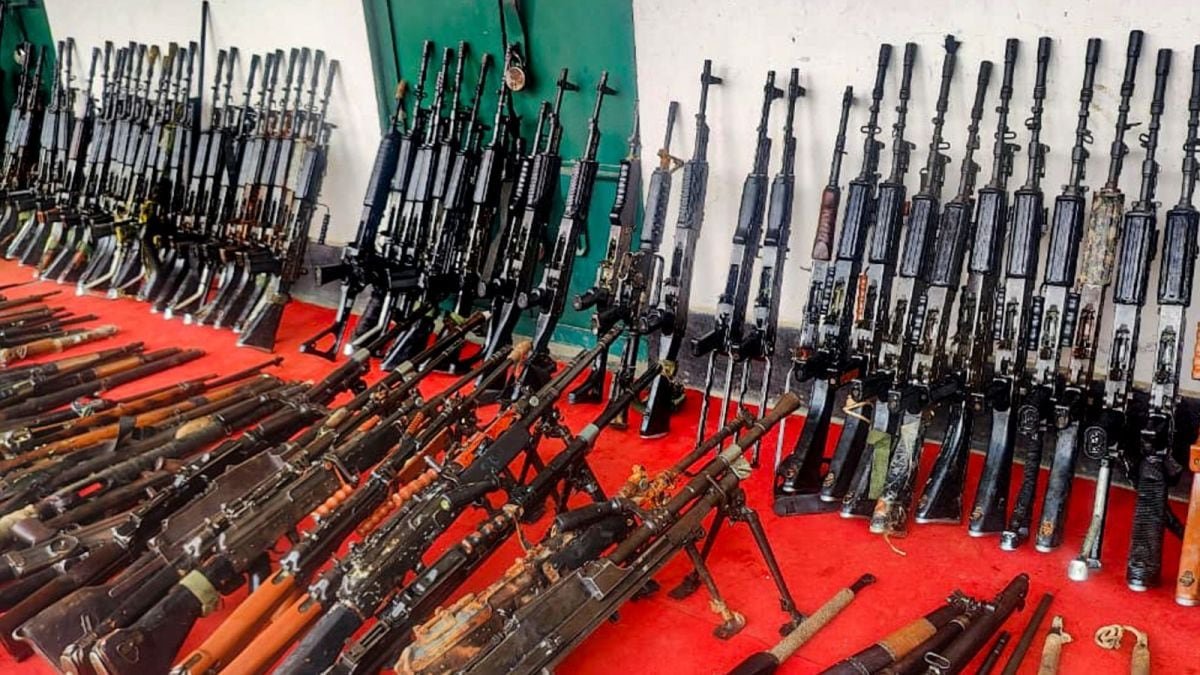 Security personnel displaying recovered INSAS rifles and grenades after operation at Langol hill in Manipur
