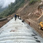 Heavy construction equipment working on strategic mountain highway development near the Line of Actual Control in Arunachal Pradesh