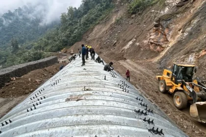 Heavy construction equipment working on strategic mountain highway development near the Line of Actual Control in Arunachal Pradesh