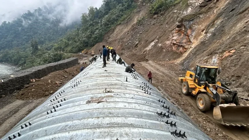 Heavy construction equipment working on strategic mountain highway development near the Line of Actual Control in Arunachal Pradesh