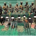 Security forces displaying seized firearm after arrest of Kuki National Army cadre in Churachandpur