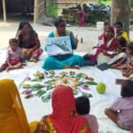 Anganwadi worker distributing nutritional supplements to pregnant women in a rural Mizoram village under a welfare scheme.