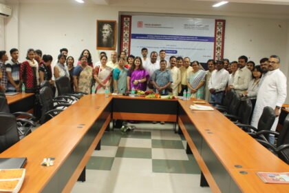 Academics and researchers discussing tribal language preservation at a national seminar hosted by Guwahati University.