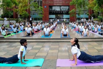 Indian Army Chief General Upendra Dwivedi leading a large group yoga session during the 12th International Yoga Day celebrations in Tezpur, Assam.