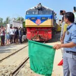 Train undergoing trial run on Agartala-Akhaura international railway line with engineers monitoring safety systems and track performance.