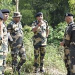 Tripura Police personnel conducting identity verification checks and security inspections near a border area.