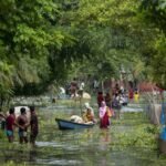 Floodwaters completely submerge villages in Charaideo district as homes, roads, and agricultural fields remain inundated during Assam's ongoing monsoon flood crisis.