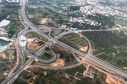 A proposed ring road infrastructure project around Guwahati showing modern highways and urban connectivity improvements supported by a government mitigation plan.