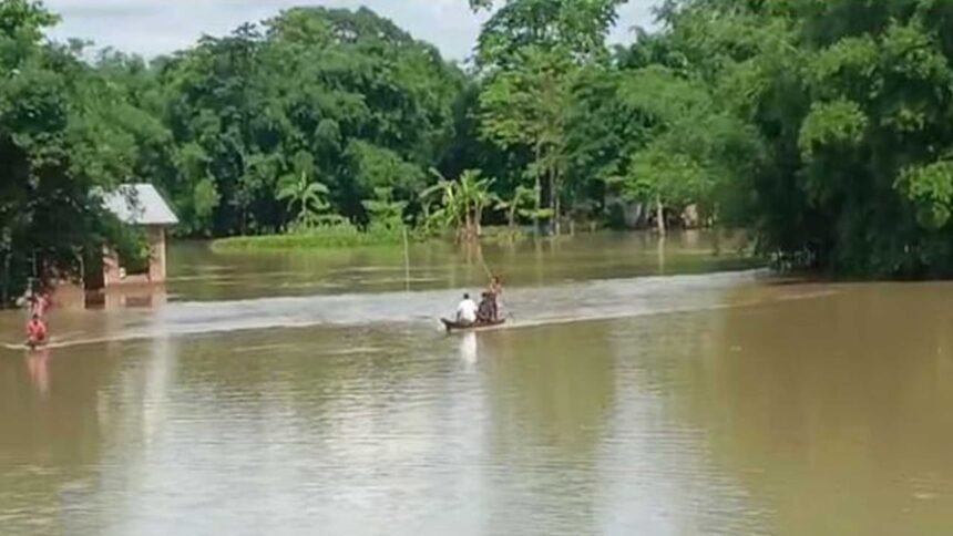 Floodwaters inundate homes and roads across Sivasagar district as residents navigate submerged neighborhoods during Assam's ongoing flood emergency affecting more than 2 lakh people.