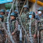 Security personnel and law enforcement agencies conducting coordinated operations and surveillance activities near an international border region in Manipur.