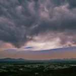 Dark monsoon clouds gather over the forested hill tracts of Northeast India as isolated heavy rainfall is forecast during the active monsoon.