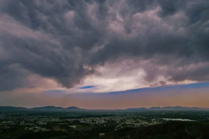 Dark monsoon clouds gather over the forested hill tracts of Northeast India as isolated heavy rainfall is forecast during the active monsoon.