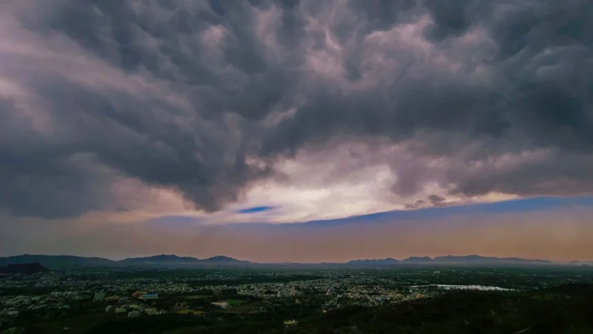 Dark monsoon clouds gather over the forested hill tracts of Northeast India as isolated heavy rainfall is forecast during the active monsoon.