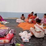 Relief workers distribute clean drinking water to flood-affected residents in Nagaon as NGOs and district teams coordinate emergency assistance.