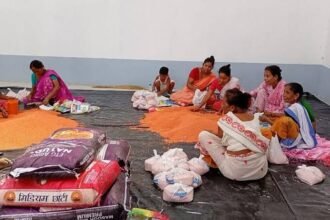 Relief workers distribute clean drinking water to flood-affected residents in Nagaon as NGOs and district teams coordinate emergency assistance.