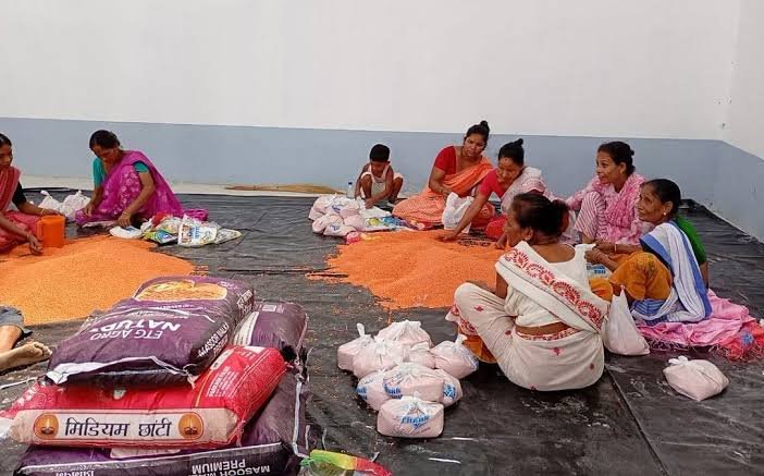 Relief workers distribute clean drinking water to flood-affected residents in Nagaon as NGOs and district teams coordinate emergency assistance.