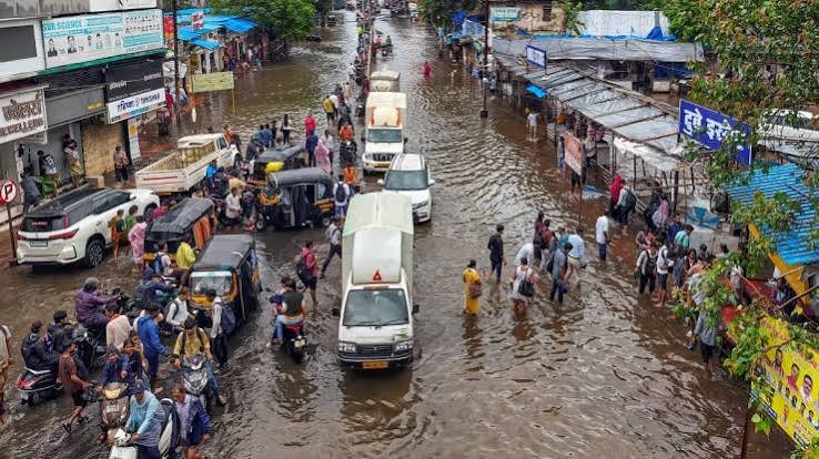 Emergency personnel assess a landslide-affected area after heavy monsoon rains as authorities respond to the incident and monitor weather conditions.