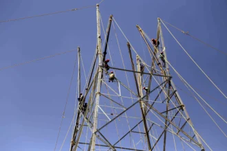 Electricity poles and power lines extend into a remote tribal village in Tripura after successful grid connectivity under a rural electrification programme.