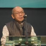 Mizoram Home Minister K. Sapdanga addresses officials during a meeting while discussing the need for a clear Central Government policy on Zo ethnic refugees.