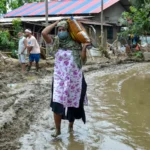Flood-affected rural communities in Assam face a rising official death toll of 98 amid widespread inundation.