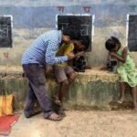 Local teachers conduct makeshift open-air classes on a dry highway divider in flood-affected Najira.