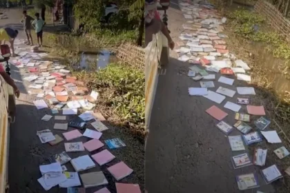 Youth volunteers in Sivasagar spread flood-damaged school textbooks along roadsides to dry and salvage educational materials.