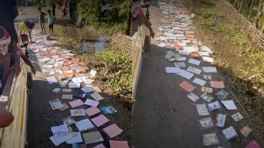 Youth volunteers in Sivasagar spread flood-damaged school textbooks along roadsides to dry and salvage educational materials.