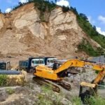 Heavy crane teams reportedly recover civilian cars trapped in deep mud following severe flooding in Nepali Khuti village.