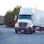 Commercial trucks move smoothly through the Pallel check-point as security personnel manage streamlined freight operations to improve logistics and maintain efficient traffic flow.