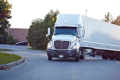 Commercial trucks move smoothly through the Pallel check-point as security personnel manage streamlined freight operations to improve logistics and maintain efficient traffic flow.