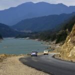 The swollen Siang River flows near Pasighat as authorities place low-lying areas on red alert due to rising floodwaters during the monsoon season.