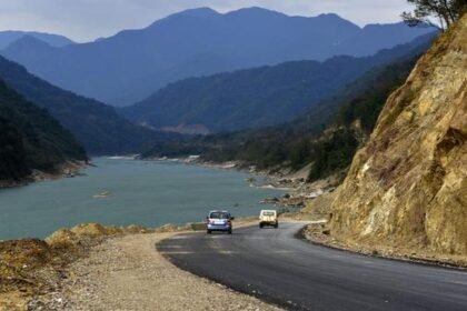 The swollen Siang River flows near Pasighat as authorities place low-lying areas on red alert due to rising floodwaters during the monsoon season.