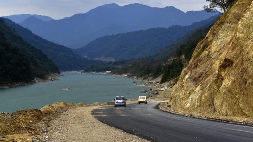 The swollen Siang River flows near Pasighat as authorities place low-lying areas on red alert due to rising floodwaters during the monsoon season.