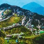 Tourists overlook Gangtok city while mountain roads remain affected by conditions that contributed to a decline in domestic visitor arrivals.