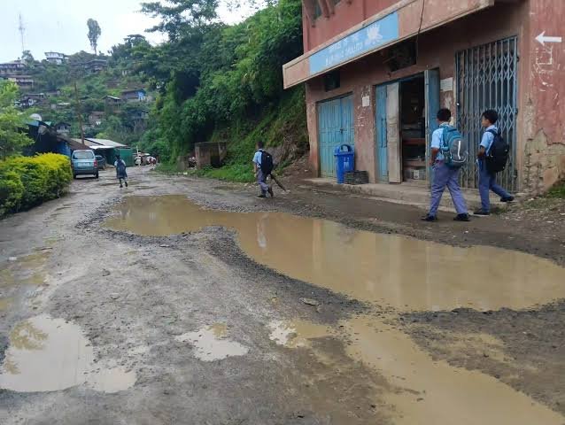 A deteriorated road with extensive potholes along the Akuluto–Mokokchung transport corridor in Nagaland.