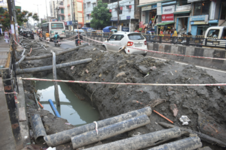 Urban infrastructure development in Guwahati featuring drainage improvement works and flyover construction projects.